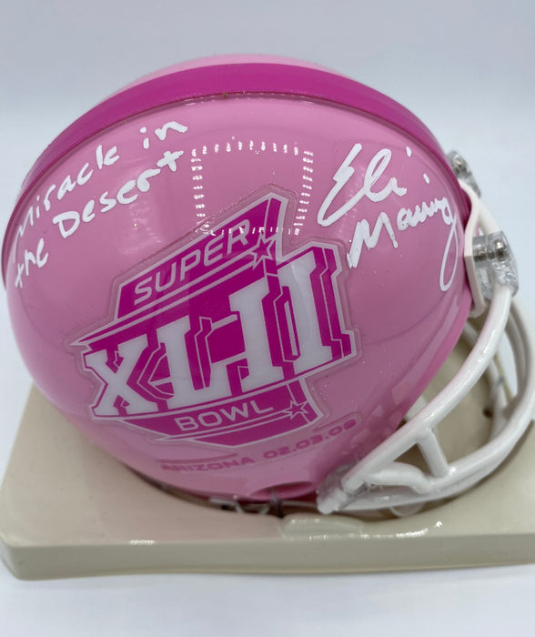 Eli Manning Autographed SB XLII PINK Breast Cancer Awareness Mini Helmet with Miracle In the Desert Inscription (Fanatics)